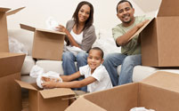 A family unpacking boxes in their home.