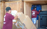 Two members of our team moving loading a storage container.